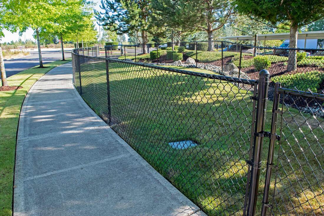 black chain link fence surrounding dog off-leash area
