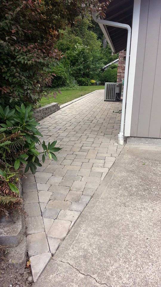 paver walkway meets concrete driveway