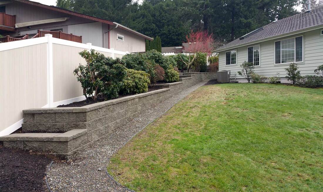after new retaining wall and vinyl fence